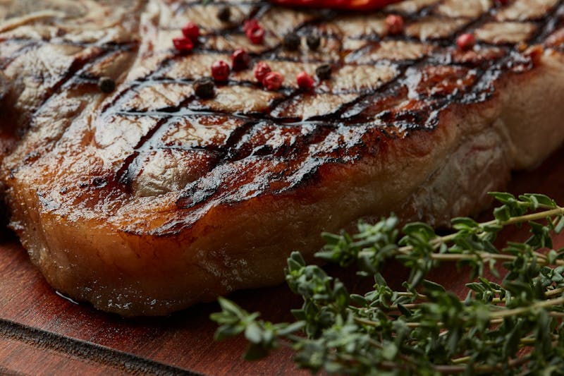Grilled ribeye steak with chimichurri sauce
